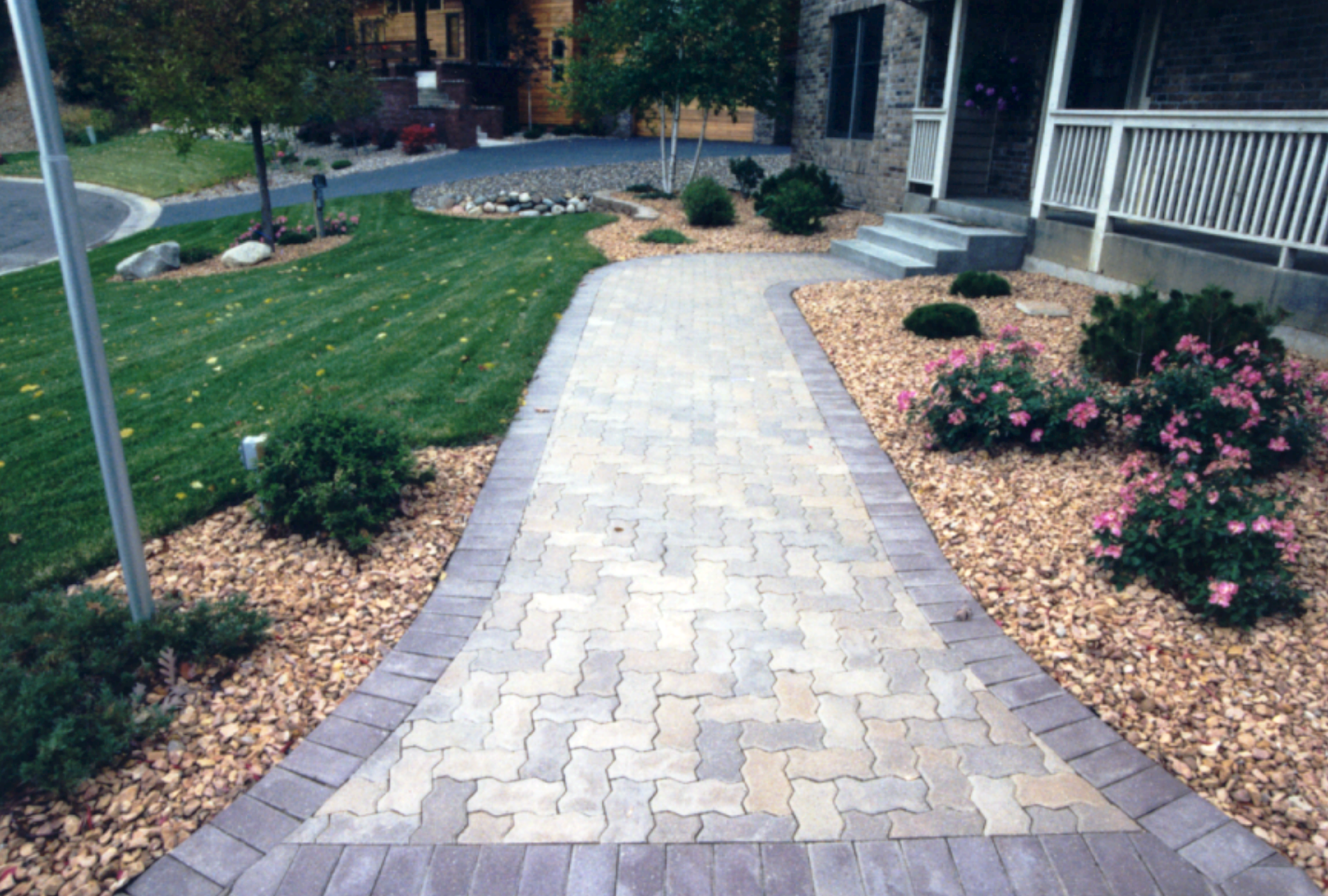 A brick walkway in front of a house.