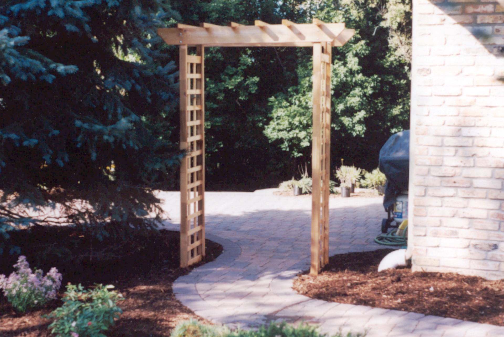 A wooden arbor in a garden.